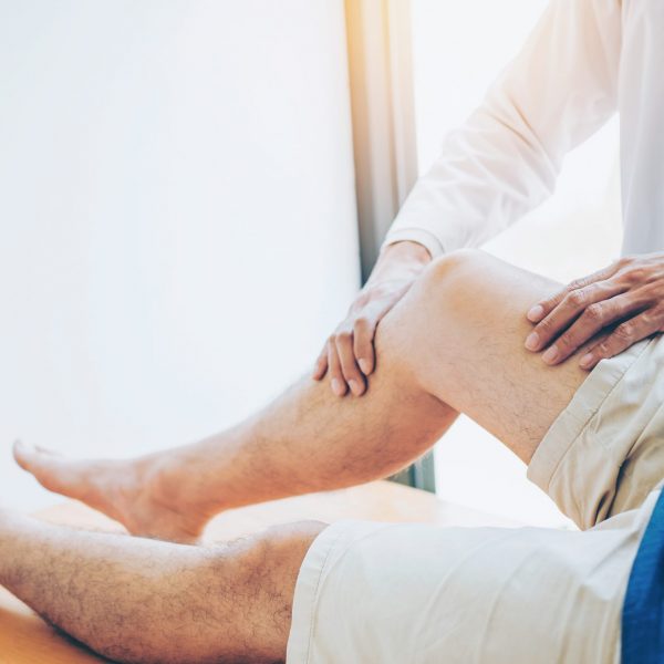 Physical Doctor consulting with patient Knee problems Physical therapy concept Physical Doctor consulting with patient Knee problems Physical therapy concept